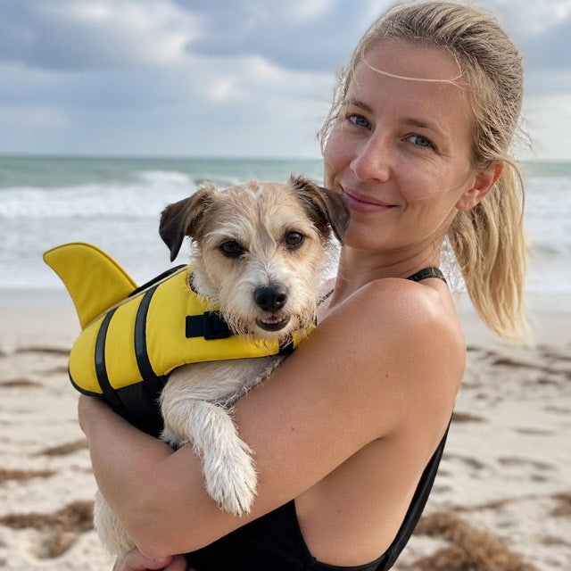 Sarah with her dog in PupFin at the beach