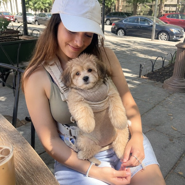 Sarah carrying her dog in a PupPerch